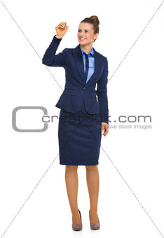 Smiling, elegant businesswoman writing in mid air