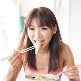 Asian girl eating dumplings