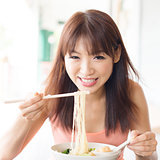 Asian girl eating ramen
