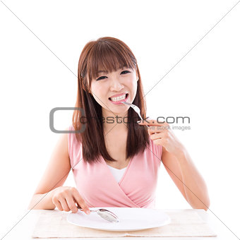 Dining concept, woman eating with empty plate