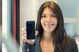 Attractive woman holding up her mobile phone