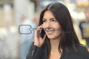 Attractive woman smiling as she chats on a mobile