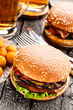 Delicious burger with fried potato balls and beer