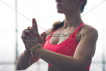 Partial view closeup of fit woman's hands in yoga pose