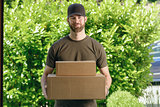 Handsome delivery man with two cardboard boxes