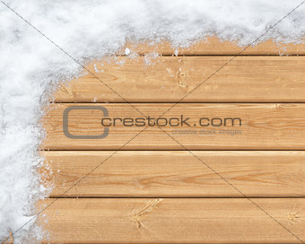Snow-covered wooden surface