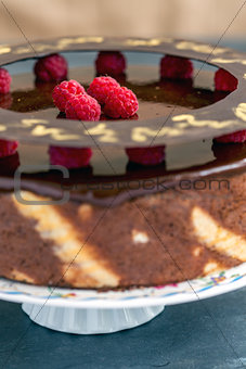 Cake with chocolate icing and raspberries