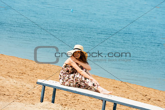 sweet girl on beach with hat resting