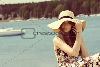 summer girl with hat near lake.vintage color