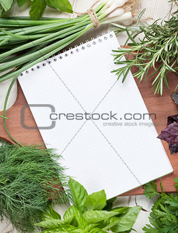 Fresh garden herbs and notepad for your recipe