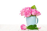 Pink roses bouquet on wooden table