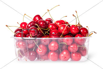 Red juicy sweet cherries in a plastic tray