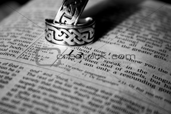 Man and Woman's Wedding Rings Resting On The Bible