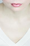 Half face of a women, neck and pink lips