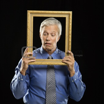 Man holding picture frame.