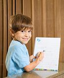 Boy showing homework.