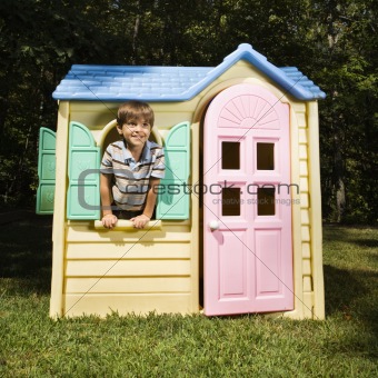 Boy in playhouse.