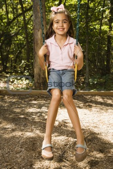 Girl swinging on swing.