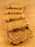 Five slices of brown bread with whole crop grains.