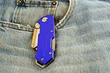Blue anodized contractors razor knife on jeans