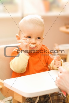 Baby boy playing with spoon