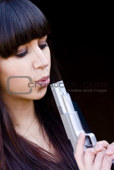 Woman blowing a gun