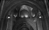 Looking through a series of arched sandstone doorways in ancient cathedral