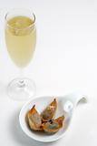 A glass of champagne with finger food