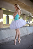 Graceful ballerina in the industrial background