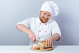 Head-cook slicing freshly baked bread