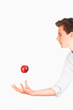 Man Tossing Red Apple in the Air 
