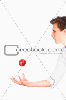 Man Tossing Red Apple in the Air 