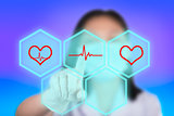 Nurse pressing cardiogram buttons show cardiology technology