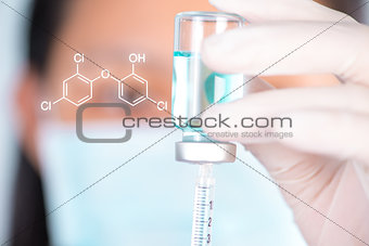 Closed up Nurse fills syringe from injection vial and chemical s