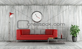 Red couch in old wooden room