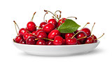 Pile of sweet cherries with leaf on white plate