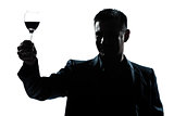 man rising up toasting his glass of red wine  silhouette