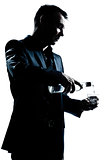 silhouette man portrait pouring white alcohol