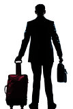 silhouette business traveler man with suitcase  rear view