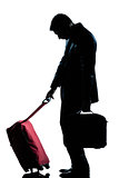 caucasian business traveler man tired with suitcase   silhouette