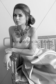 bw shot of rich girl on ancient sofa 