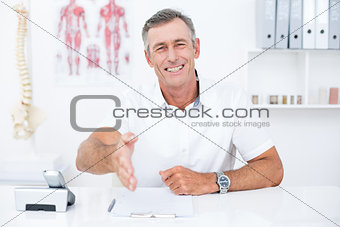 Smiling doctor offering his hand