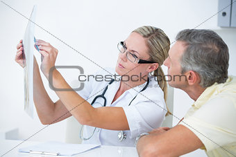 Doctor showing X rays to her patient
