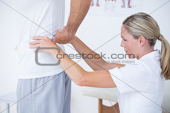 Doctor examining her patient back
