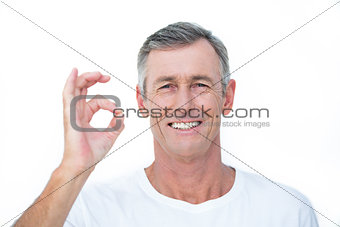 Smiling patient looking at camera and gesturing ok sign