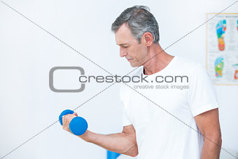 Patient lifting dumbbell