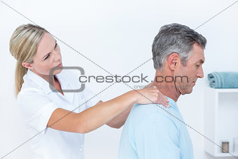 Doctor stretching her patient neck