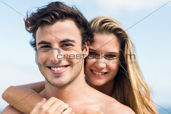 Happy couple in swimsuit embracing