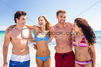 Happy friends having fun beside the water