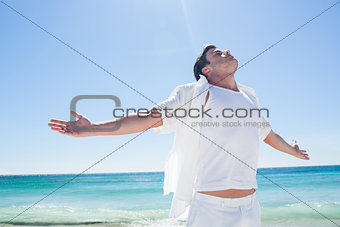 Man stretching his arms in front of the sea